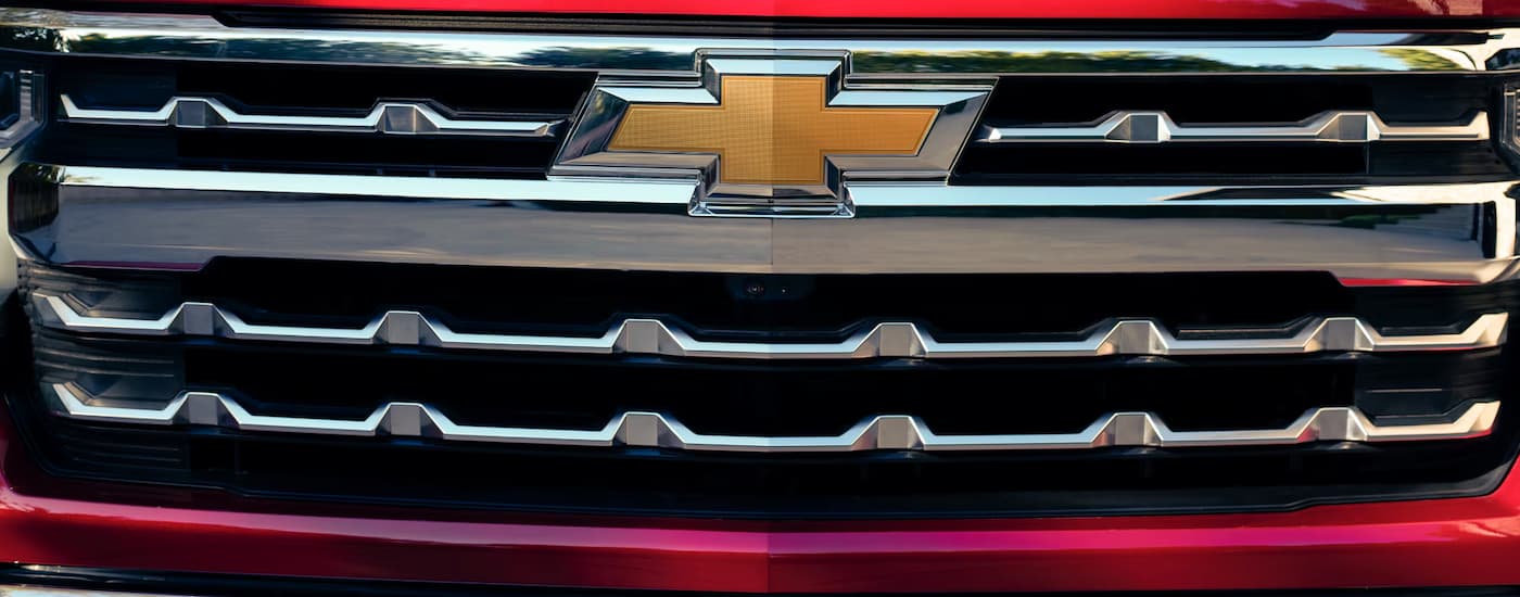 Front grille of a red 2025 Chevy Silverado 1500