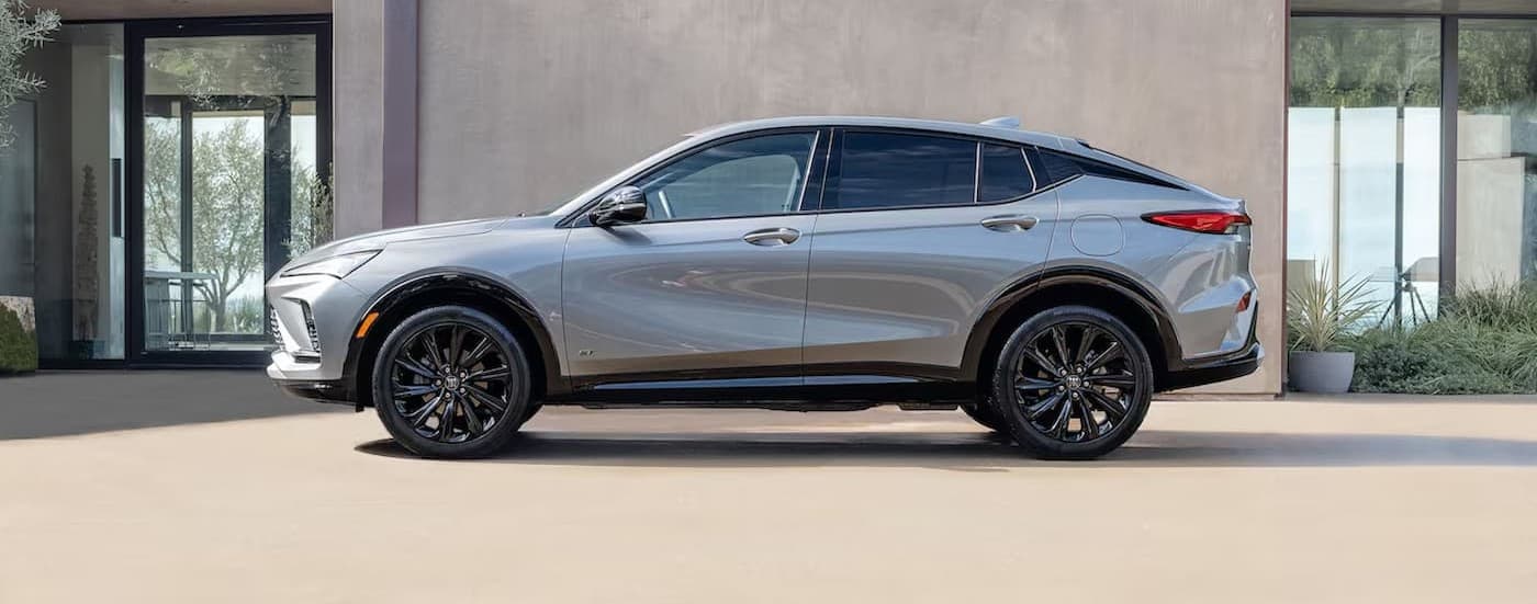 A silver 2025 Buick Envista parked near a Buick dealer.